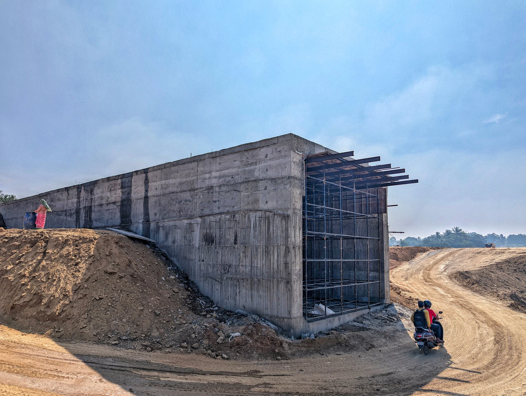Concrete formwork and completed walls at a flyover project